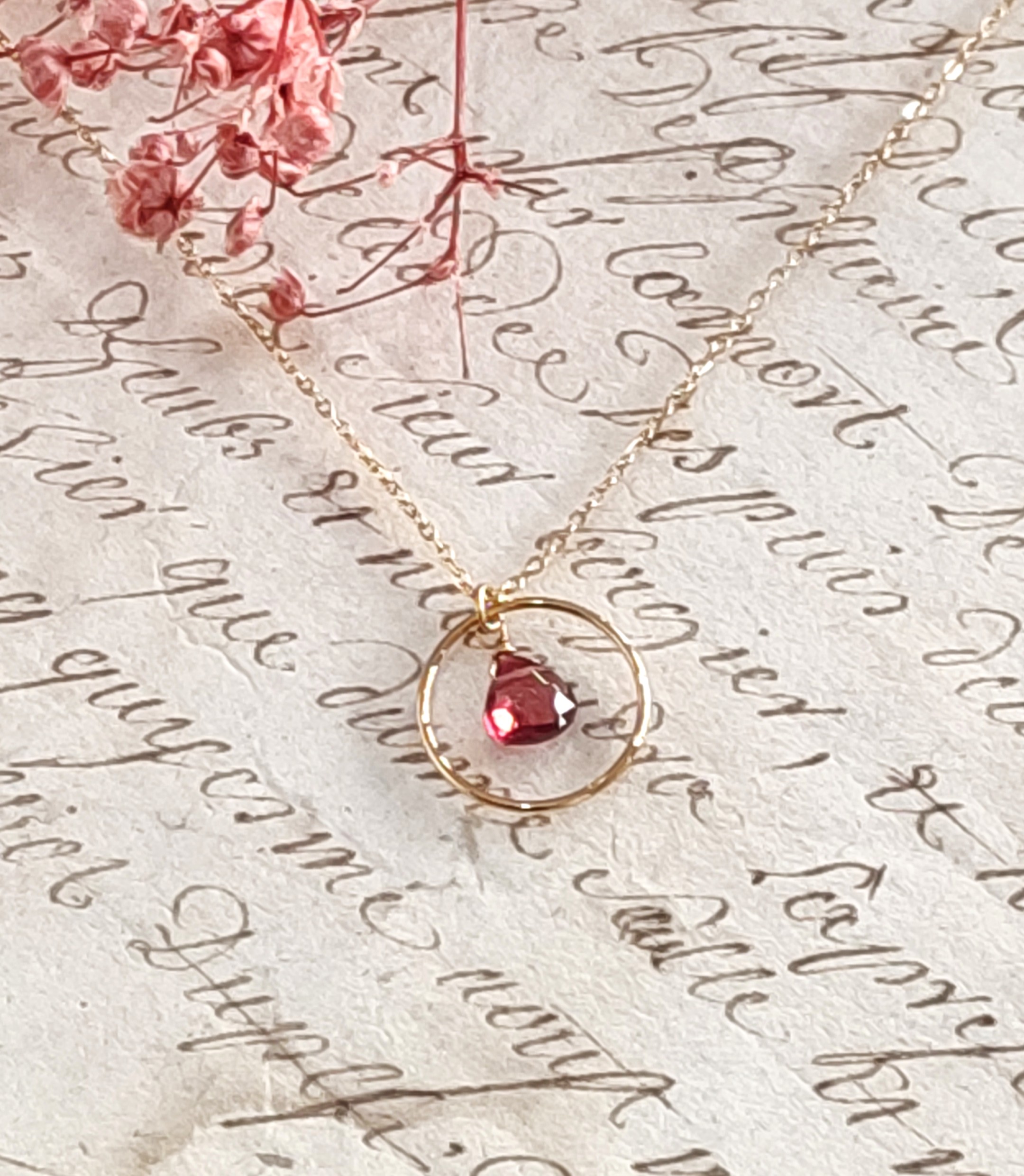 L’élégance du noir et de l’or : découvrez notre collier fin anneau et goutte couleur grenat en acier doré 3 microns. Un bijou minimaliste et lumineux, idéal pour offrir.